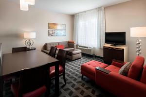 a living room with a couch and a table and chairs at TownePlace Suites by Marriott San Diego Carlsbad / Vista in Vista