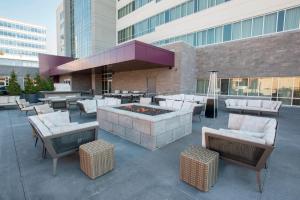 a patio with a fire pit and chairs and a building at Residence Inn by Marriott Cincinnati Midtown/Rookwood in Cincinnati