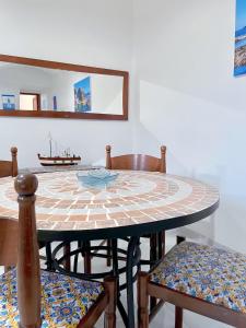 a dining room with a table and chairs at Aeolian Apartments in Lipari