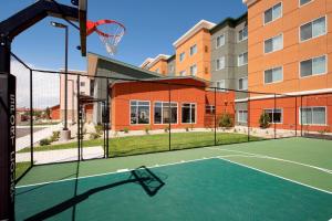 a tennis court with a basketball hoop in front of a building at Residence Inn by Marriott Denver Airport/Convention Center in Denver