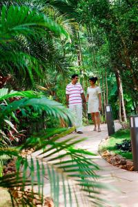 a man and a woman walking down a path at Goa Marriott Resort & Spa in Panaji