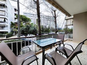 a balcony with a table and chairs and a view of a city at Dimitsanas by Verde Apartments in Athens