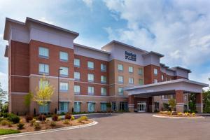 a building with a parking lot in front of it at Fairfield Inn & Suites Charlotte Pineville in Charlotte