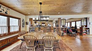 a dining room with a table and chairs at Ravensong Lodge in New Auburn