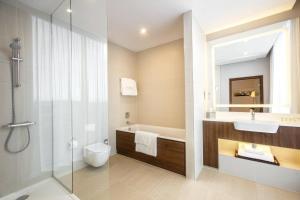 a bathroom with a toilet and a sink and a shower at Courtyard by Marriott Edinburgh West in Edinburgh