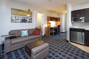 a living room with a couch and a table and a kitchen at TownePlace Suites Tucson in Tucson