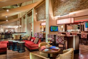 a lobby with a bar and a restaurant at Houston Marriott Westchase in Houston