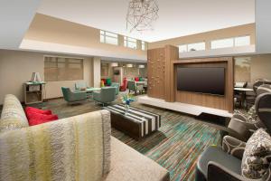 a living room with a couch and a flat screen tv at Residence Inn by Marriott Miami Airport West/Doral in Miami