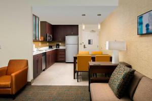 a living room with a couch and a kitchen at Residence Inn by Marriott Miami Airport West/Doral in Miami