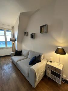 a living room with a couch and a table at Entre Loire et Chateau in Blois