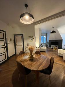 a living room with a table and chairs and a living room at Entre Loire et Chateau in Blois