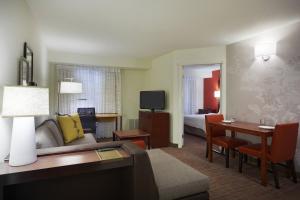 a hotel room with a couch and a table and a bed at Residence Inn by Marriott San Antonio Downtown Market Square in San Antonio