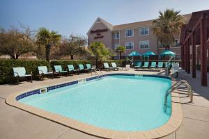 a swimming pool with chairs and a hotel at Residence Inn by Marriott San Antonio Downtown Market Square in San Antonio