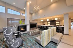 a living room with a fireplace and a bar at Residence Inn by Marriott Houston Tomball in Tomball