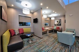 a waiting room with a couch and chairs and tables at Residence Inn by Marriott Houston Tomball in Tomball