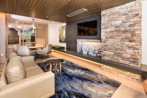 a living room with a couch and a stone fireplace at Fairfield Inn & Suites by Marriott Crestview in Crestview