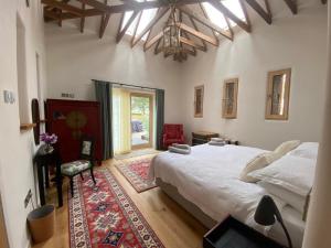 a bedroom with a large bed and a window at The Stables - Luxury Cottage in Dumfries