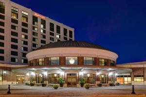 a large building with a round building at night at Newport News Marriott at City Center in Newport News