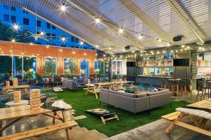 a large room with tables and couches and tablesktop at Aloft Austin Downtown in Austin