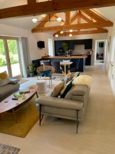 a living room with a couch and a table at The Stables - Luxury Cottage in Dumfries