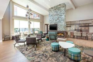 a lobby with a fireplace and tables and chairs at Residence Inn Livermore in Livermore