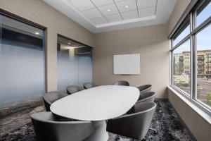 a meeting room with a white table and chairs at AC Hotel by Marriott Pittsburgh Southpointe in Canonsburg