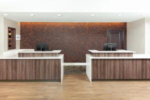 an office lobby with two reception desks and a wall at Residence Inn Livermore in Livermore
