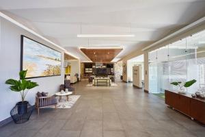 an office lobby with a hallway with tables and chairs at Fairfield Inn & Suites Silao Guanajuato Airport in Silao