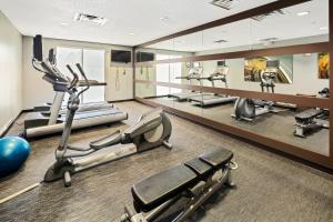 a gym with treadmills and elliptical machines at Courtyard by Marriott Bryan College Station in College Station