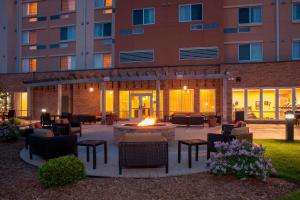 a patio with a fire pit in front of a building at Courtyard Milwaukee Airport in Milwaukee