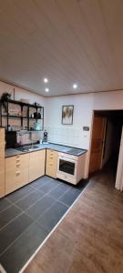 a kitchen with a sink and a stove top oven at Ferienwohnung Müller in Wadern +8 photos