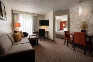 a living room with a couch and a room with a bedroom at Residence Inn Milpitas Silicon Valley in Milpitas