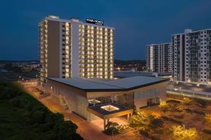 a hotel building with a lit up building at Four Points by Sheraton Desaru in Desaru