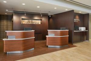 a lobby with a reception desk at Courtyard by Marriott Kingston Highway 401 in Kingston
