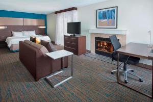 a hotel room with a bed and a fireplace at Residence Inn Philadelphia Valley Forge in Berwyn