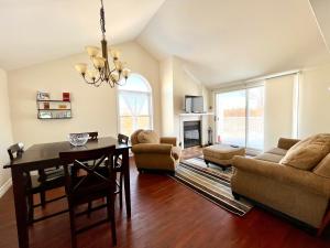 a living room with a table and chairs and a dining room at Chaleureux condo à Magog in Magog-Orford