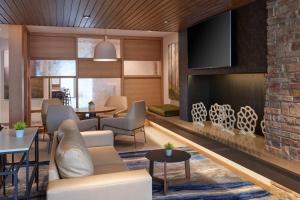 a lobby with a couch and chairs and a fireplace at Fairfield Inn & Suites by Marriott Midland in Midland