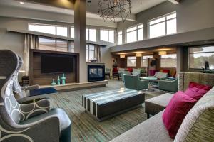 a living room with a fireplace and a tv at Residence Inn by Marriott Philadelphia Valley Forge/Collegeville in Collegeville