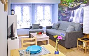 a living room with a couch and a table at Aire de Sanabria in El Puente