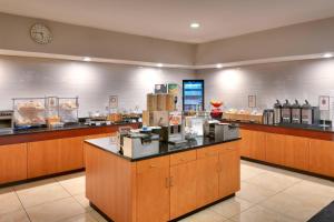 a large kitchen with a counter in a restaurant at Fairfield Inn & Suites Seattle Bellevue/Redmond in Bellevue