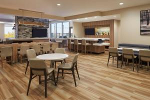 a restaurant with tables and chairs and a bar at Residence Inn by Marriott Toronto Mississauga Southwest in Mississauga