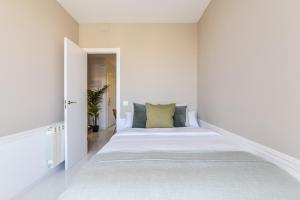 Una cama o camas en una habitación de Apartamento Embajadores XIII