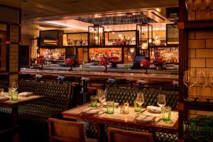 a restaurant with tables and chairs and a bar at MOXY NYC Times Square in New York