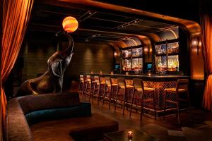 a bar with an elephant statue in a room at MOXY NYC Times Square in New York