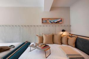 a living room with a couch and a table at MOXY NYC Times Square in New York