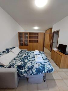 a bedroom with a bed and a television in it at La casetta in Val Masino in Val Masino