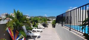 a balcony with benches and a view of the water at Hotel San Miguel Imperial in Santa Marta