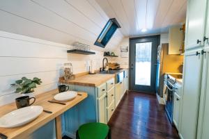 a small kitchen with a wooden counter and a sink at Modern A Frame in the woods. Pet friendly in Brook Park