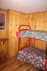 two bunk beds in a room with wooden walls at Baita "Lou Tzatagni" Pialemont Champorcher - CIR VDA - PONTBOSET 0002 in Pontboset
