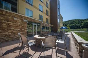 a patio with chairs and a table in front of a building at Fairfield by Marriott Cambridge in Cambridge